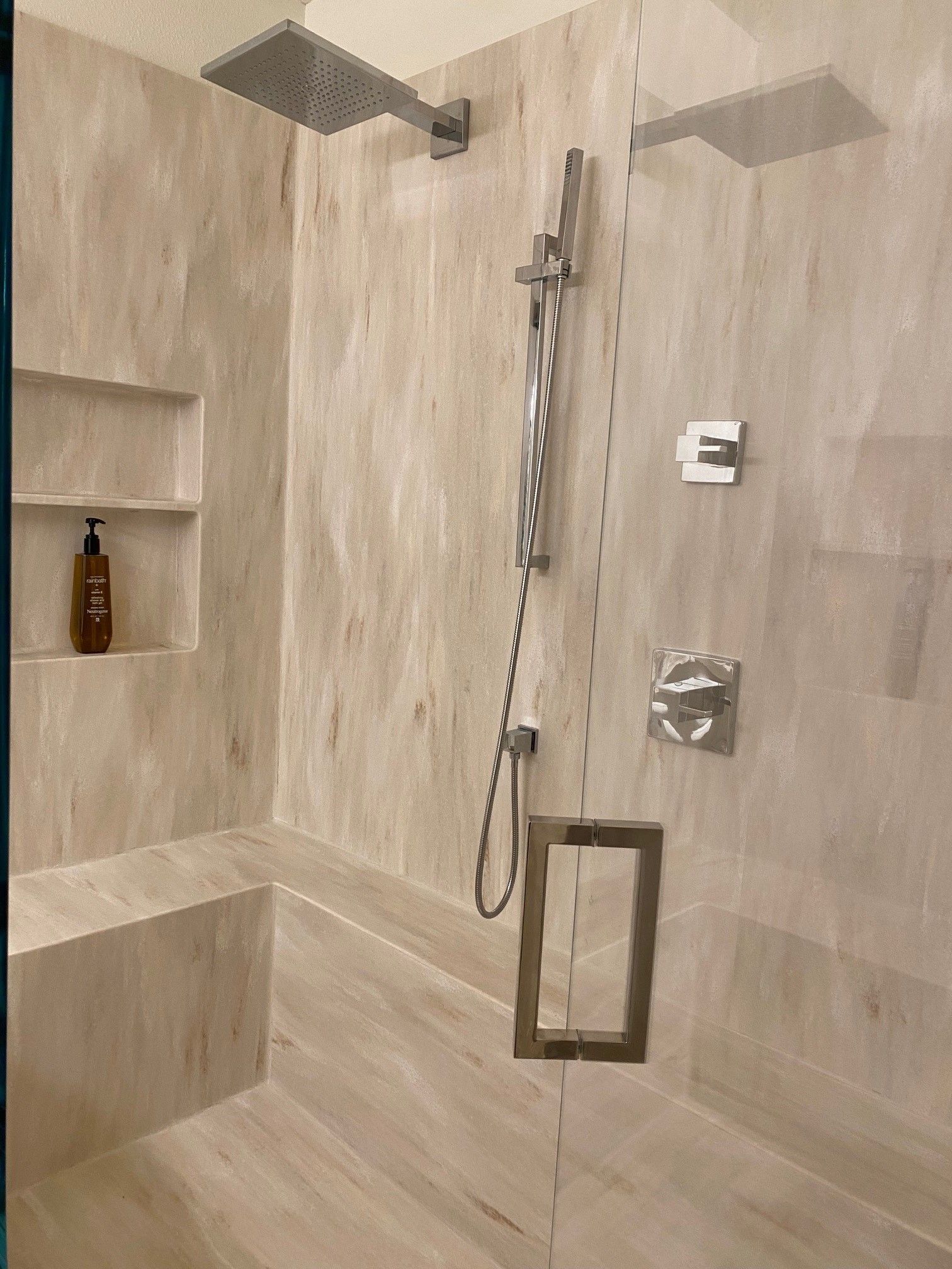 A bathroom with a shower head and a bathtub.