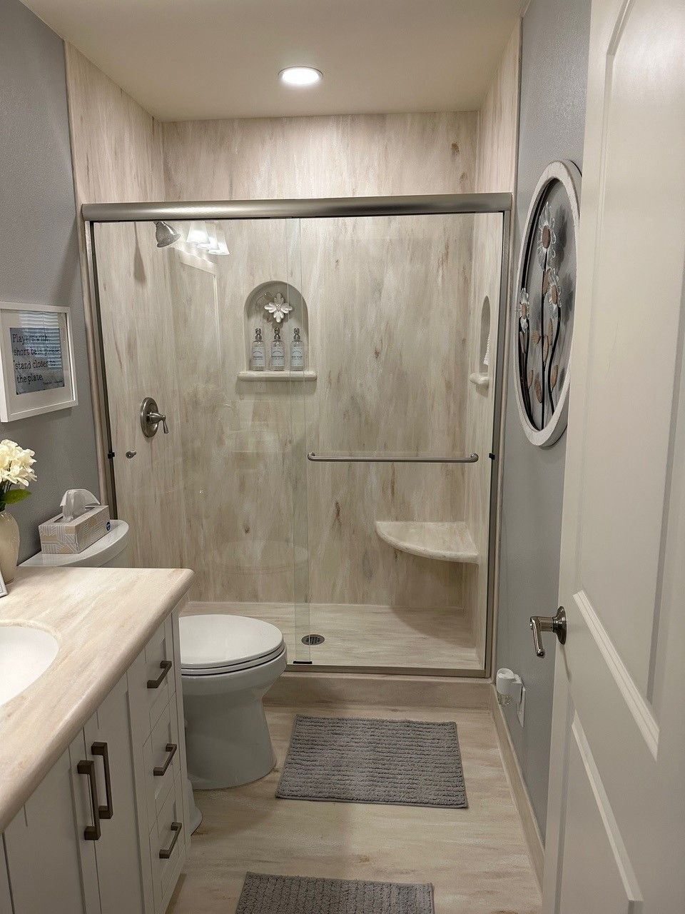 A bathroom with a toilet , sink , and shower.
