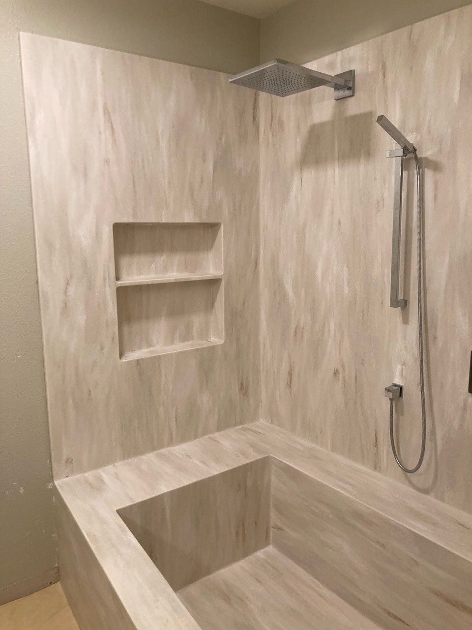 A bathroom with a bathtub and a shower.