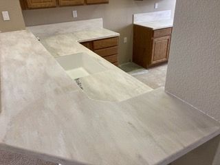 A kitchen with a large counter top and a sink.