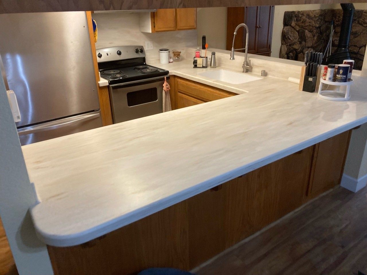 A kitchen with stainless steel appliances and a white counter top