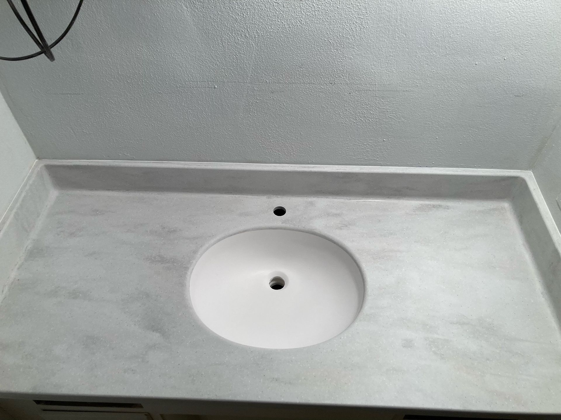 A bathroom sink with a round hole in the middle of it.