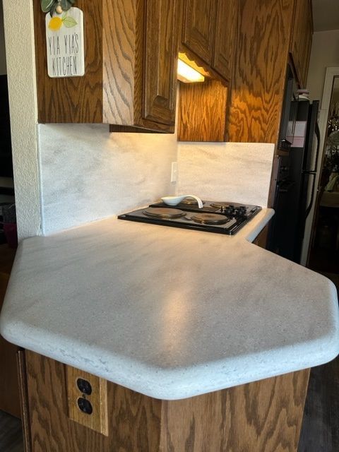 A kitchen counter with a stove top oven and a sign that says no dogs allowed.