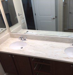 A bathroom with two sinks and a large mirror.