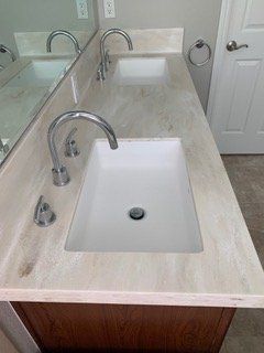 A bathroom with two sinks and a mirror.