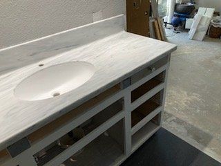 A bathroom vanity with a sink and drawers underneath it.