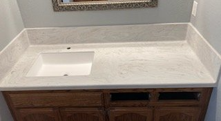 A bathroom vanity with a sink and a mirror.