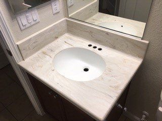 A bathroom vanity with a sink and a mirror.