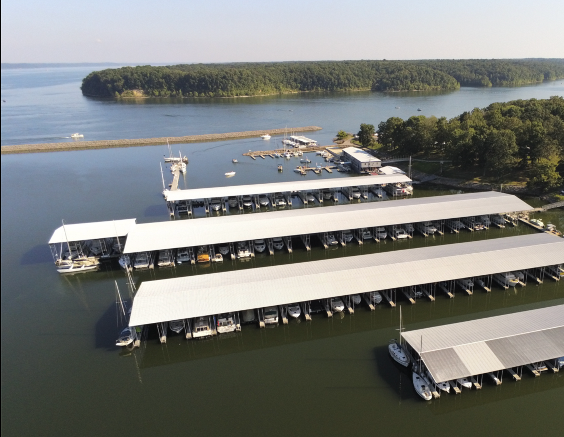 An aerial view of a marina with boats docked in it.