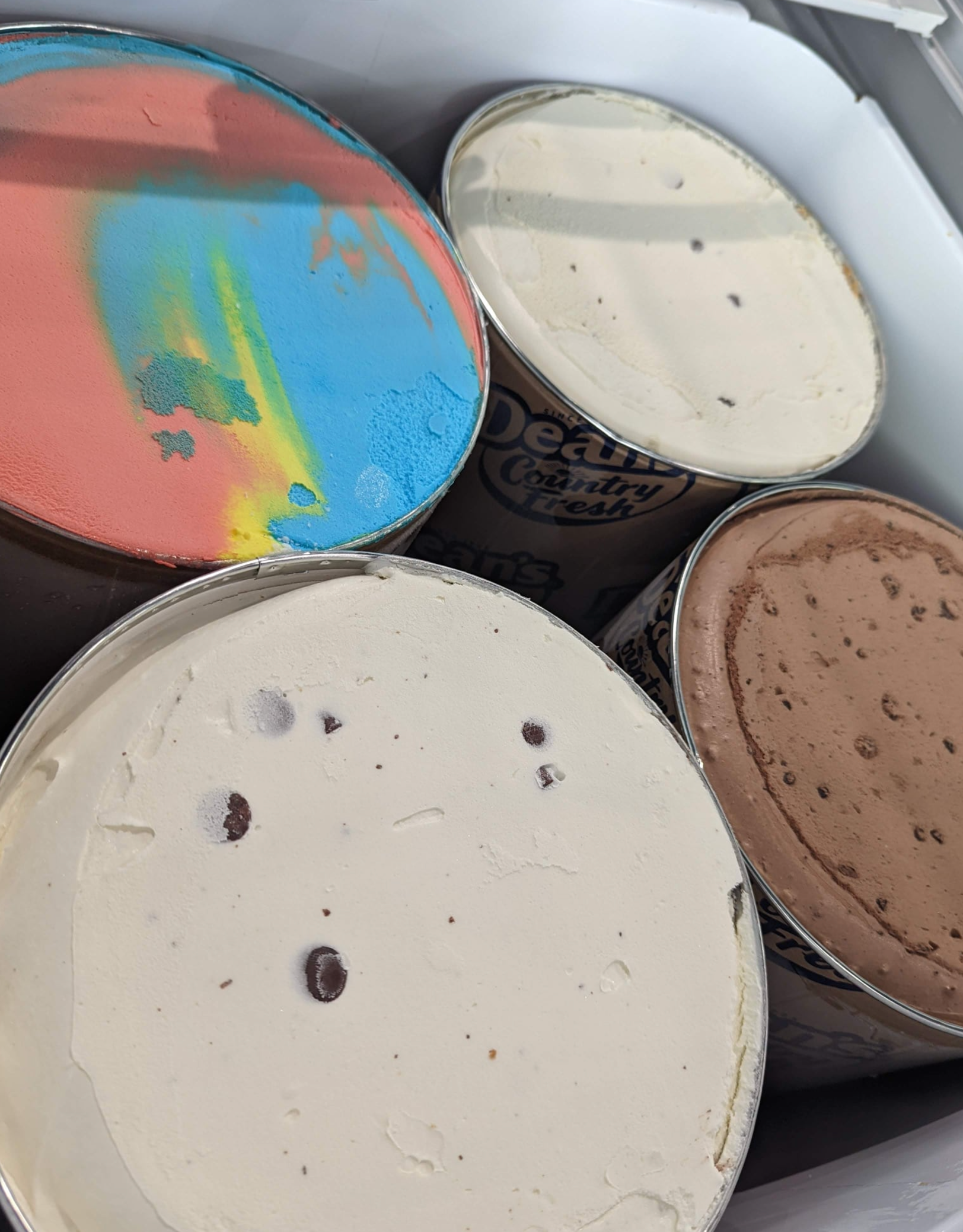 Four different flavors of ice cream are in a cooler