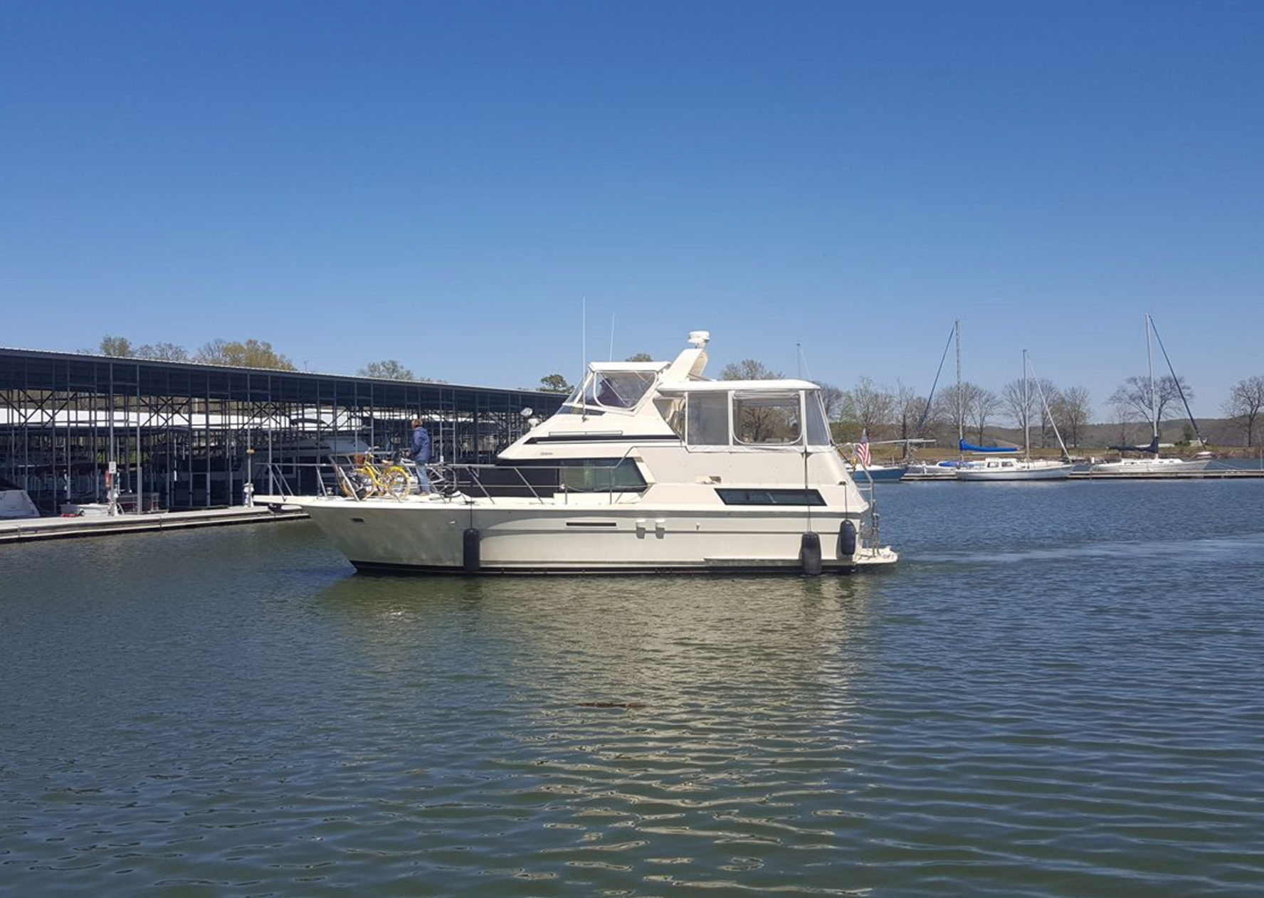 A large white boat is floating on top of a body of water.