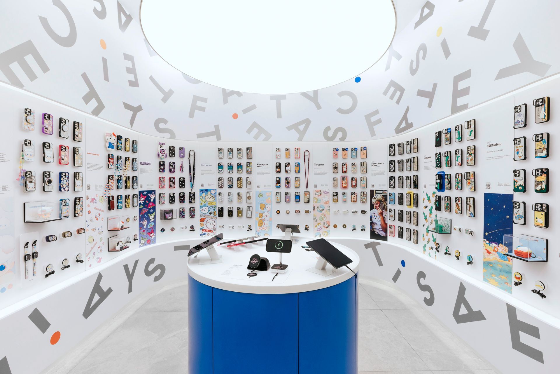 Interior of a phone accessory store with various cases displayed on walls and a central blue counter.
