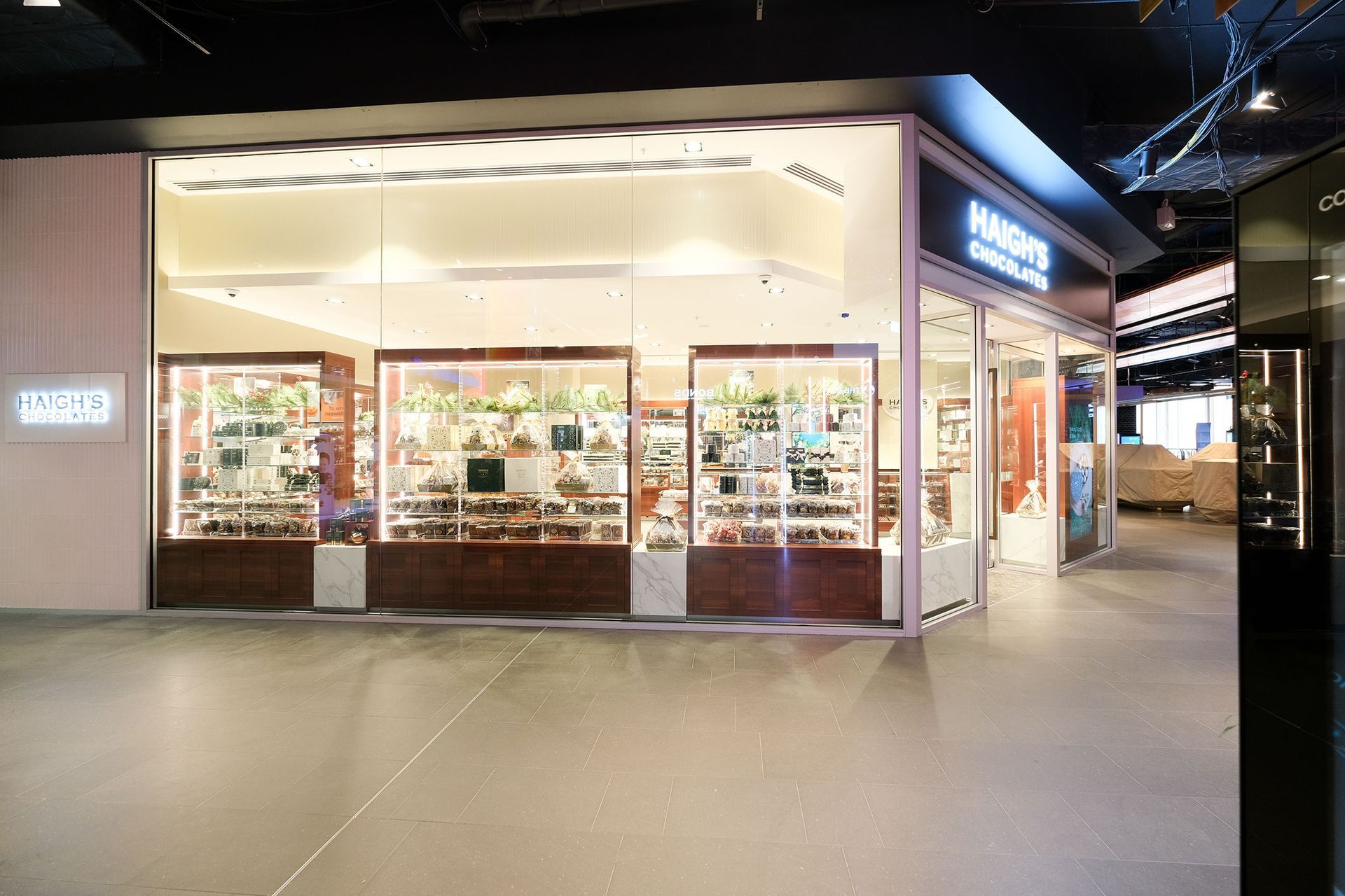 Storefront with glass windows displaying jewelry. Interior is lit with overhead lights.