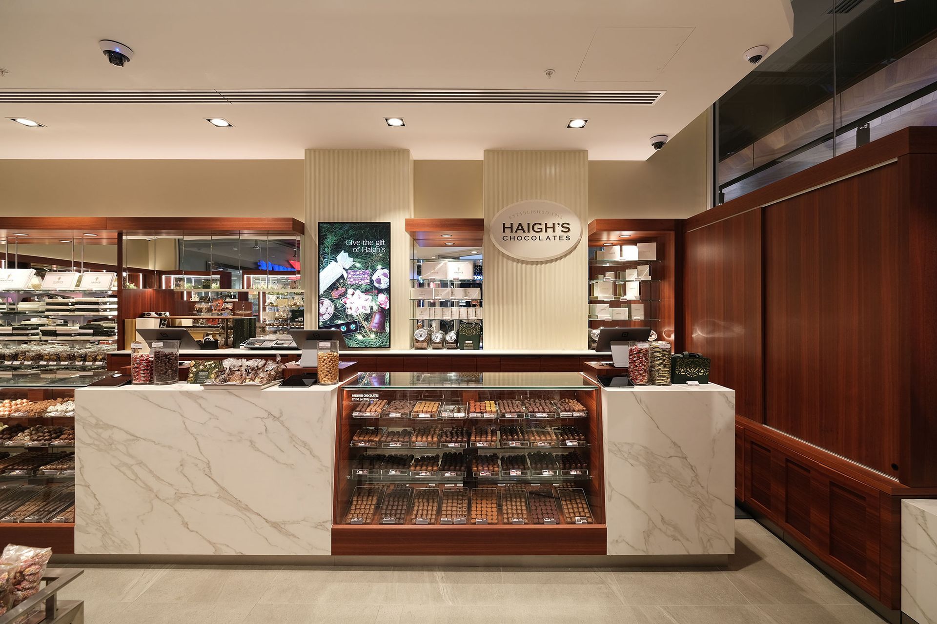 A retail store interior with a display counter featuring various products.