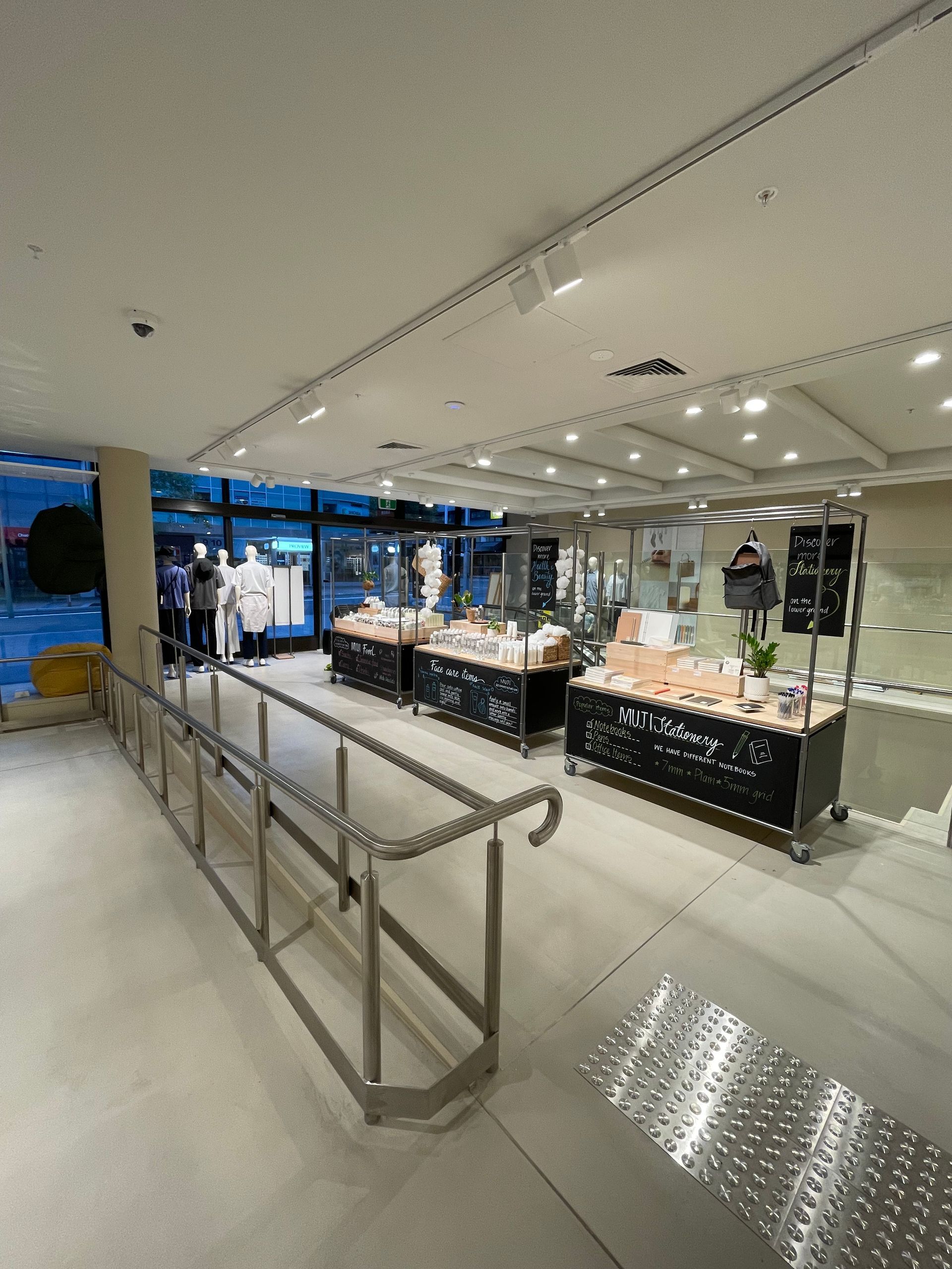 Interior store with a ramp for accessibility, merchandise displays.