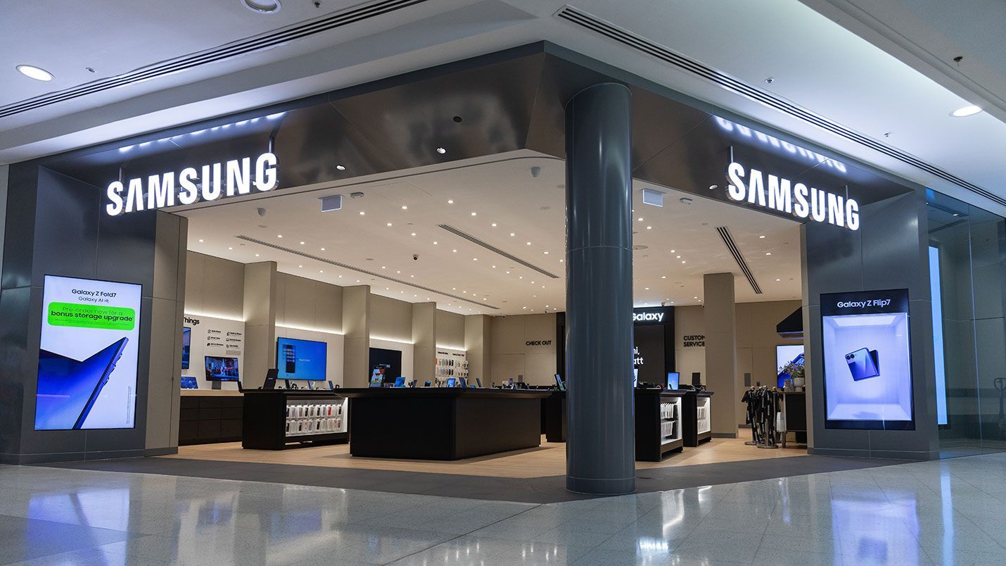 Samsung store in a mall with lit signage, displays of electronics and a polished floor.
