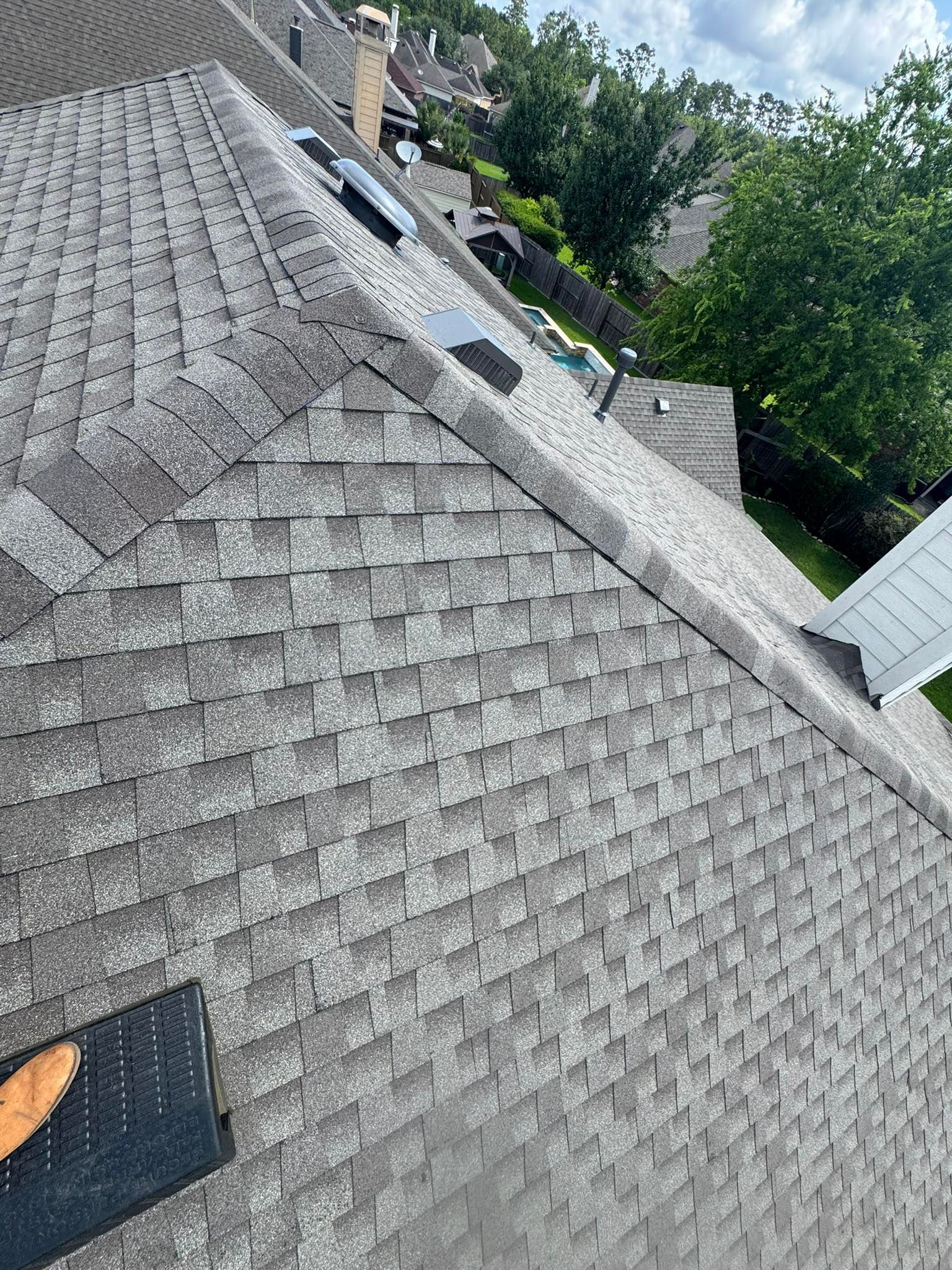 A person is standing on the roof of a house.