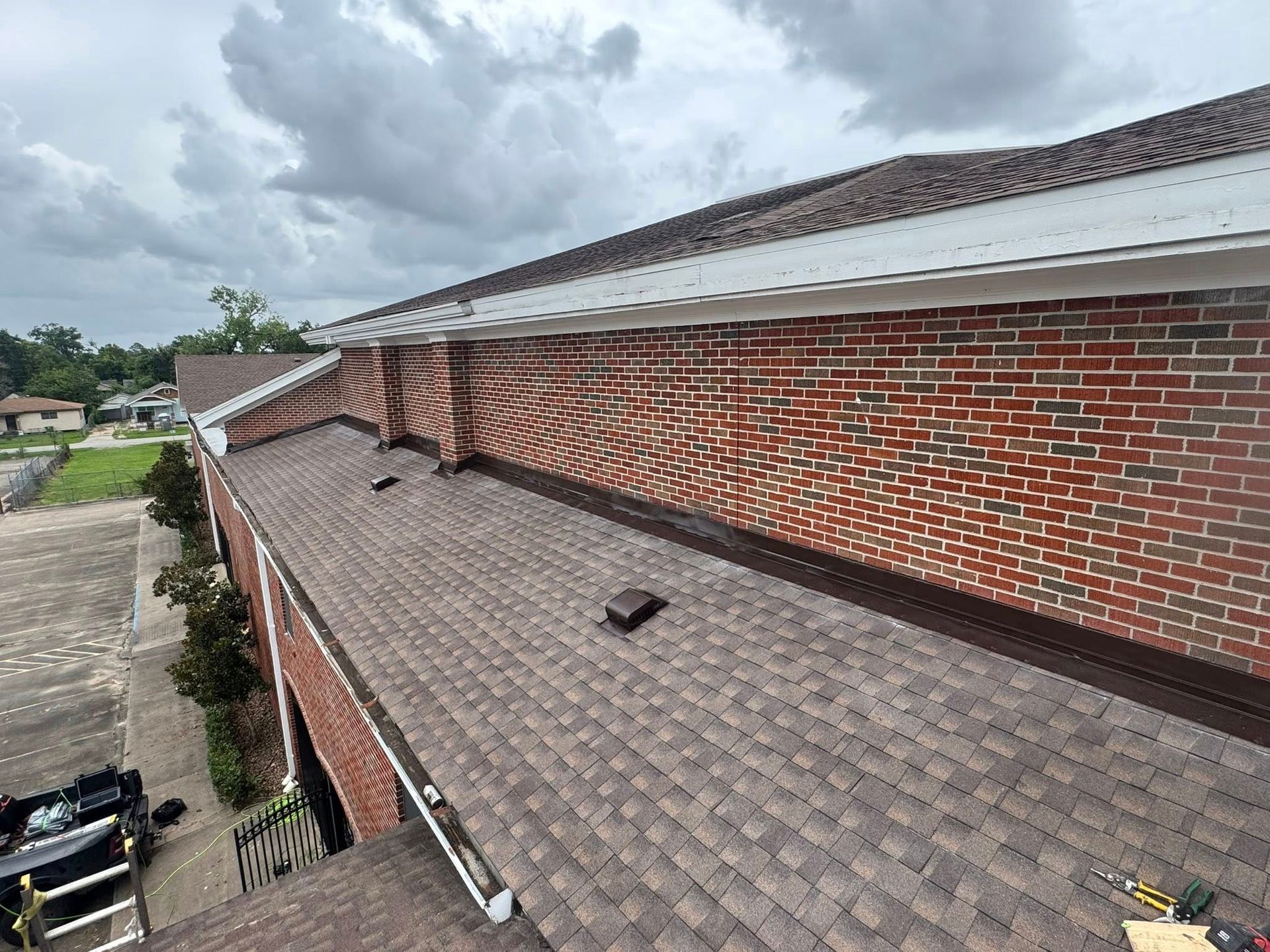An aerial view of a roof of a brick building.