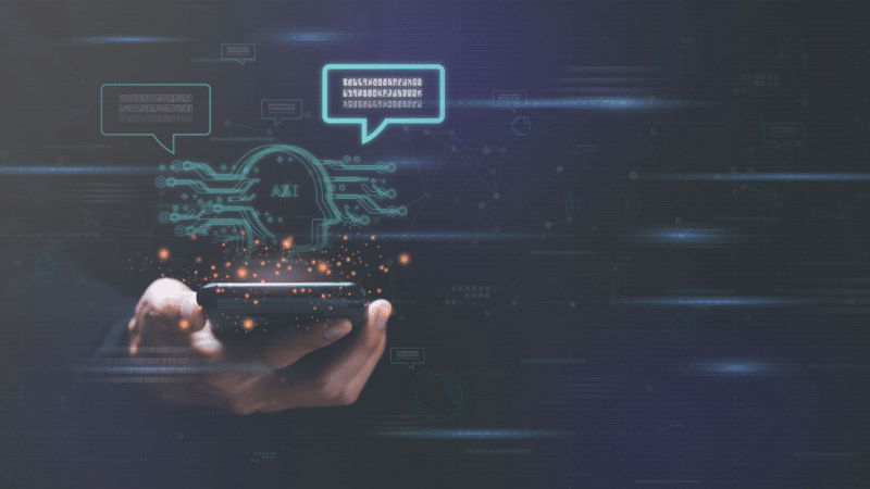 Hand holding phone, AI head icon with chat bubbles, binary code, digital background.