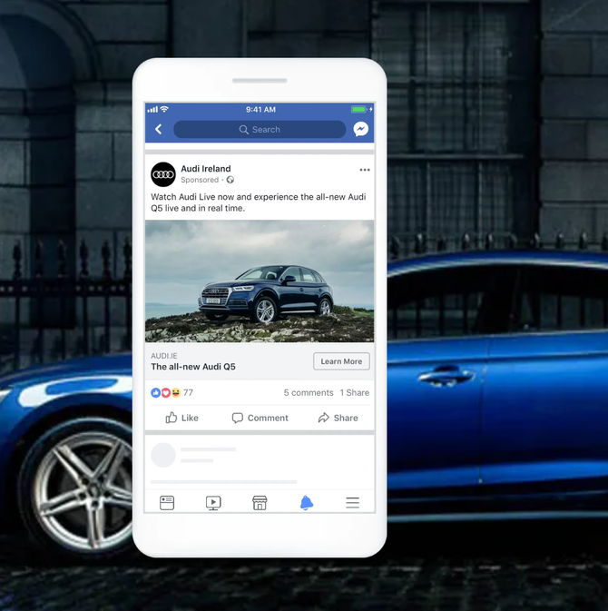 A Facebook ad on a phone showcasing a blue Audi car. The post promotes the new Audi Q3, with the car pictured outdoors.