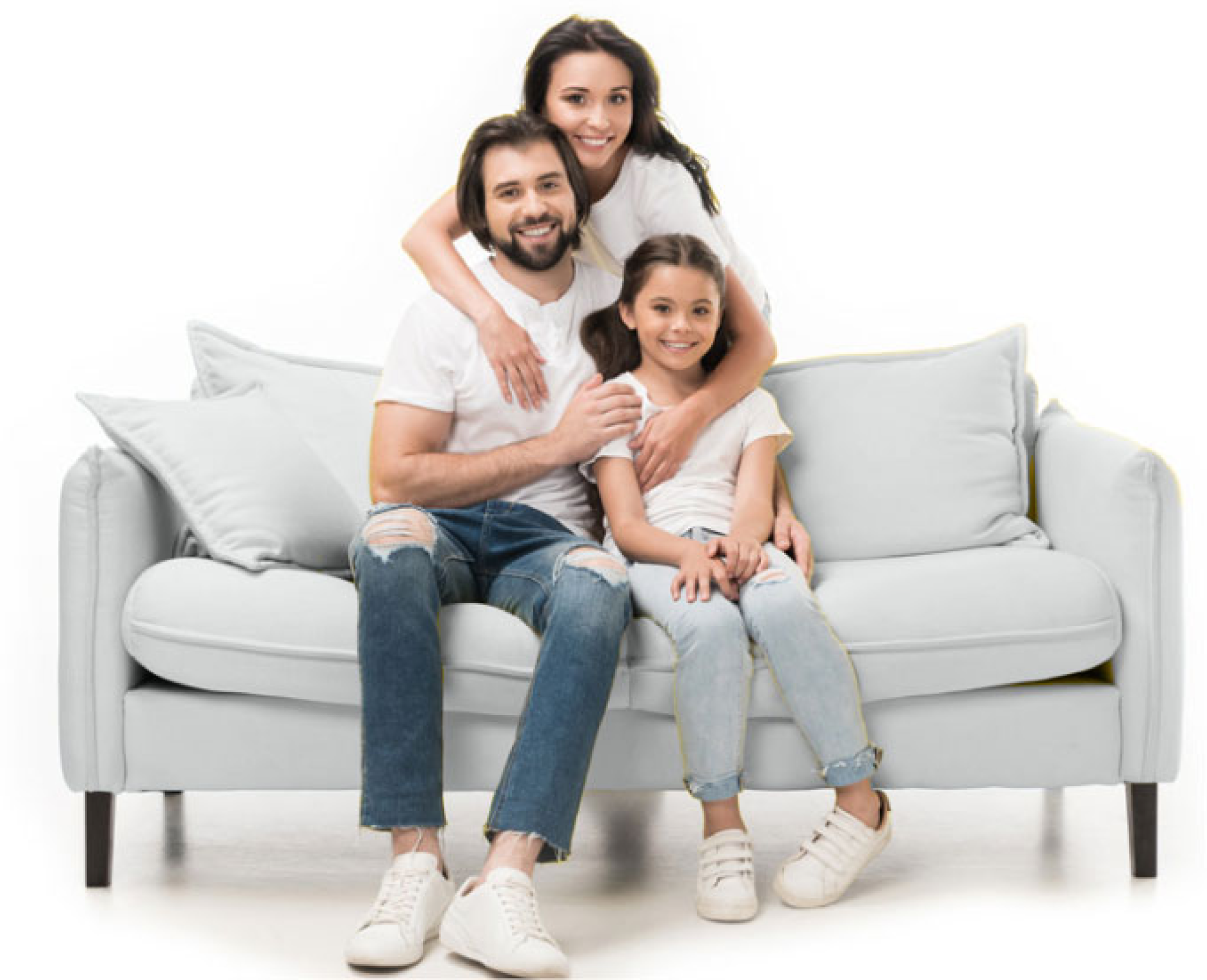 A family is sitting on a couch posing for a picture.
