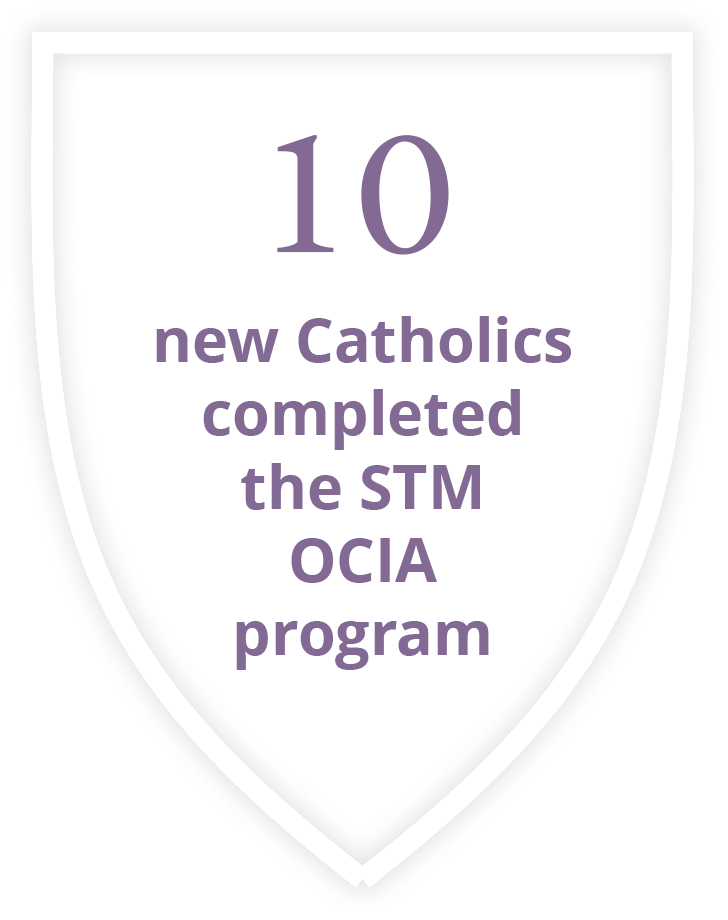 A shield with the words `` new catholics welcomed through OCIA'' on it.