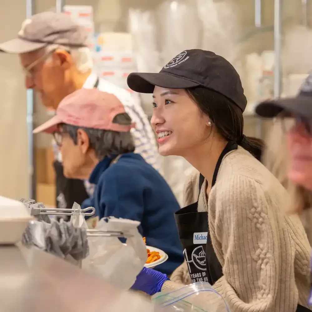 A man and a woman are preparing food in a kitchen.