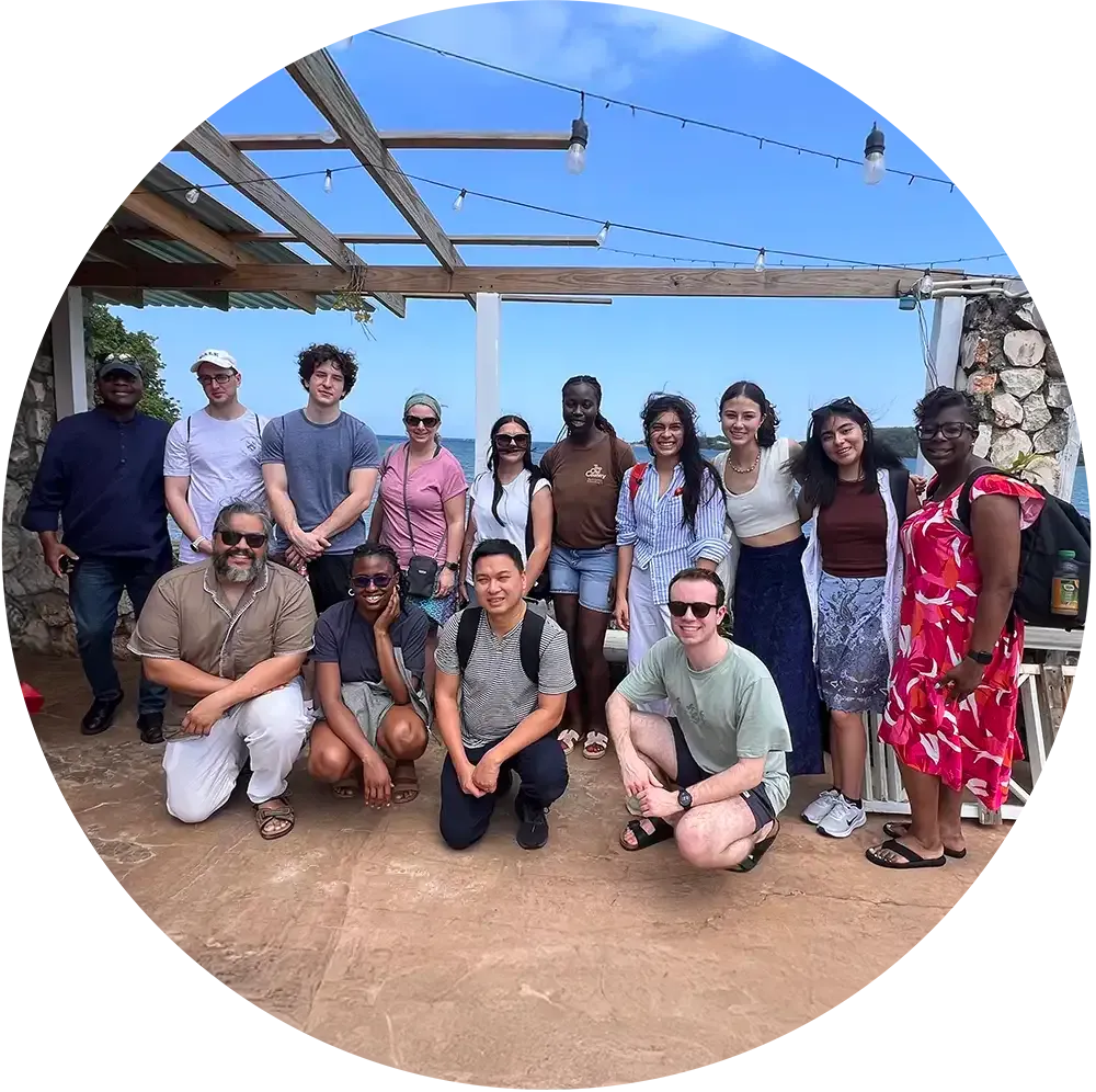 A group of people posing for a picture in front of a building