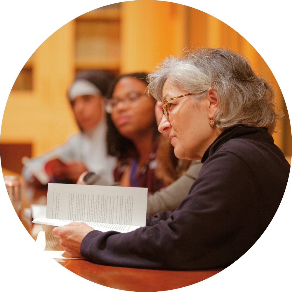 Two women posing for a picture with one wearing a shirt that says s.t.m.