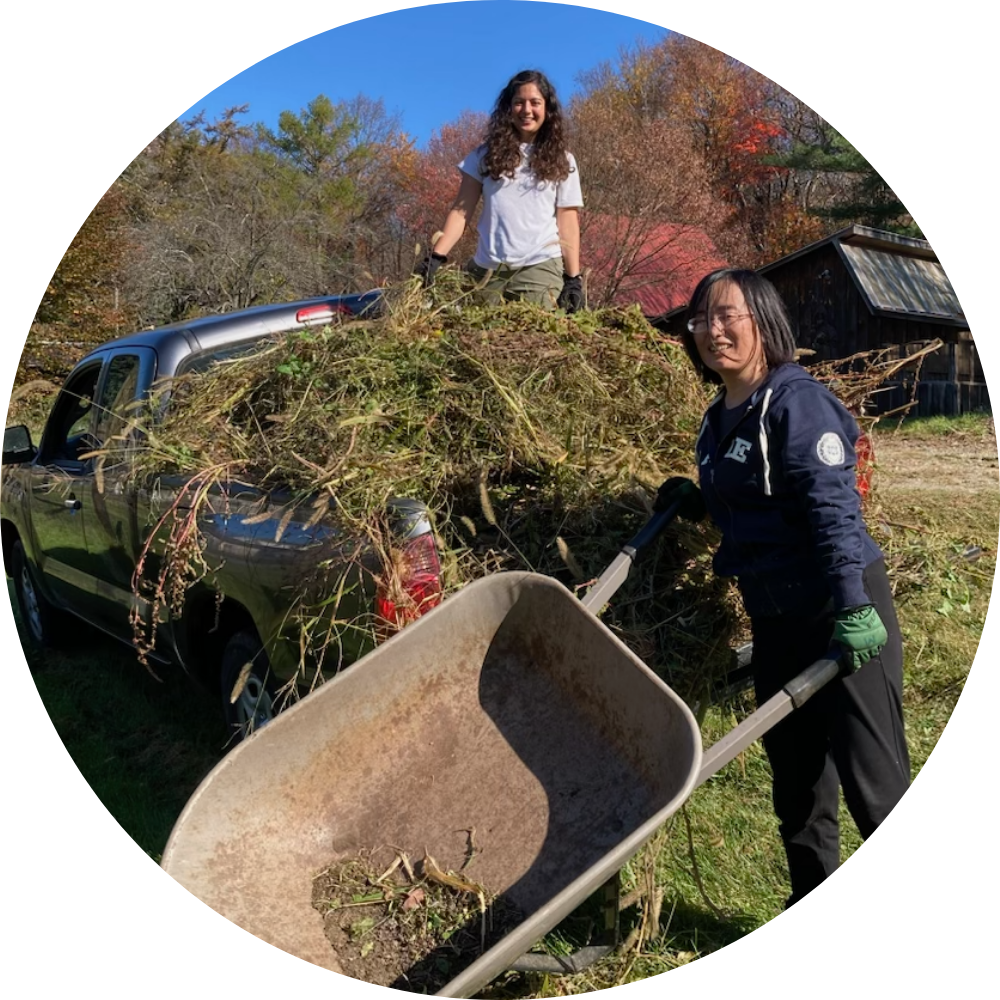 A man in a blue robe is holding a lit candle