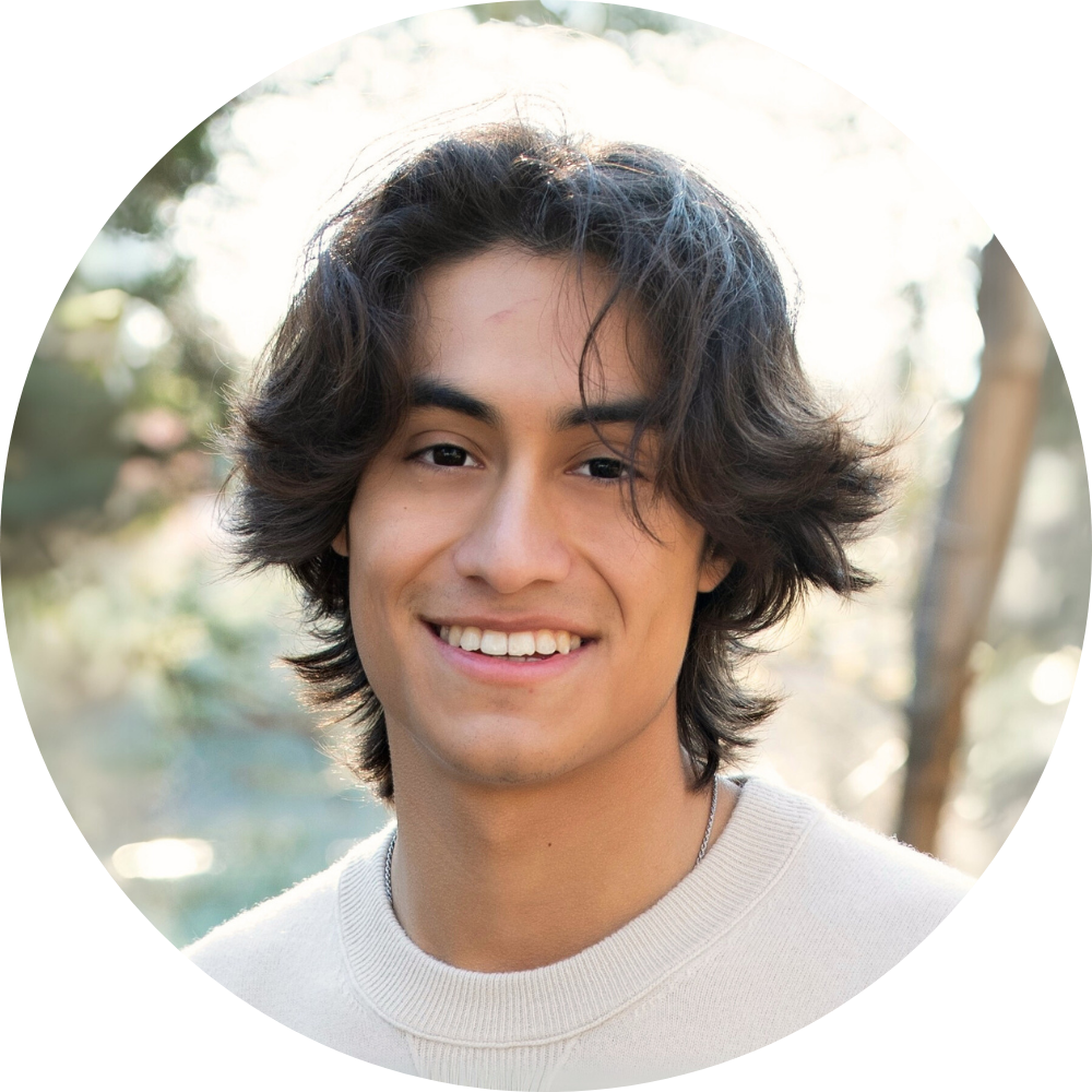 A woman in a red shirt is smiling for the camera.
