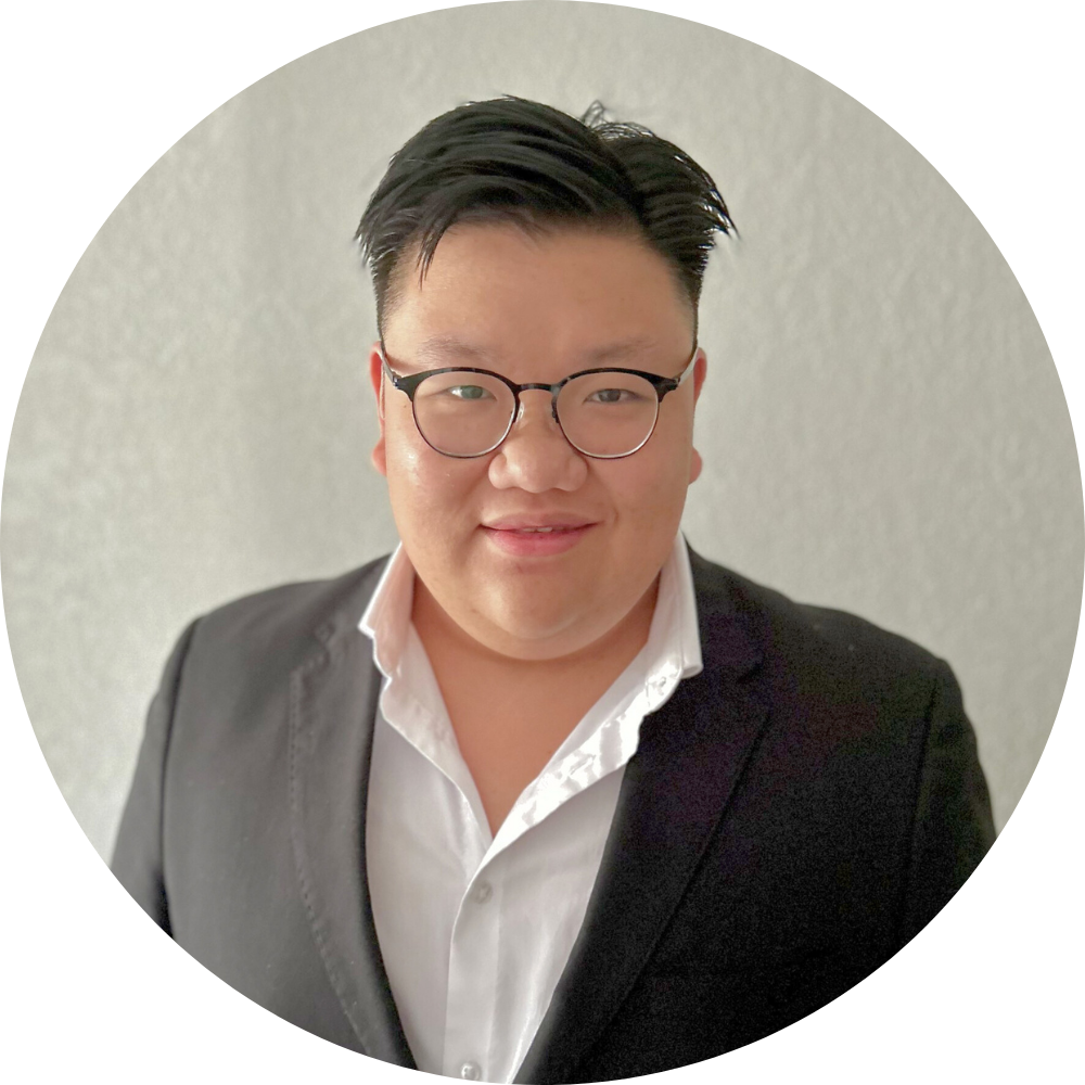 A woman wearing a necklace and earrings is smiling for the camera.