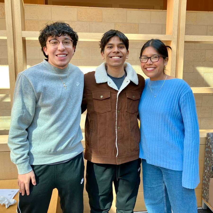 Three people smiling at the camera