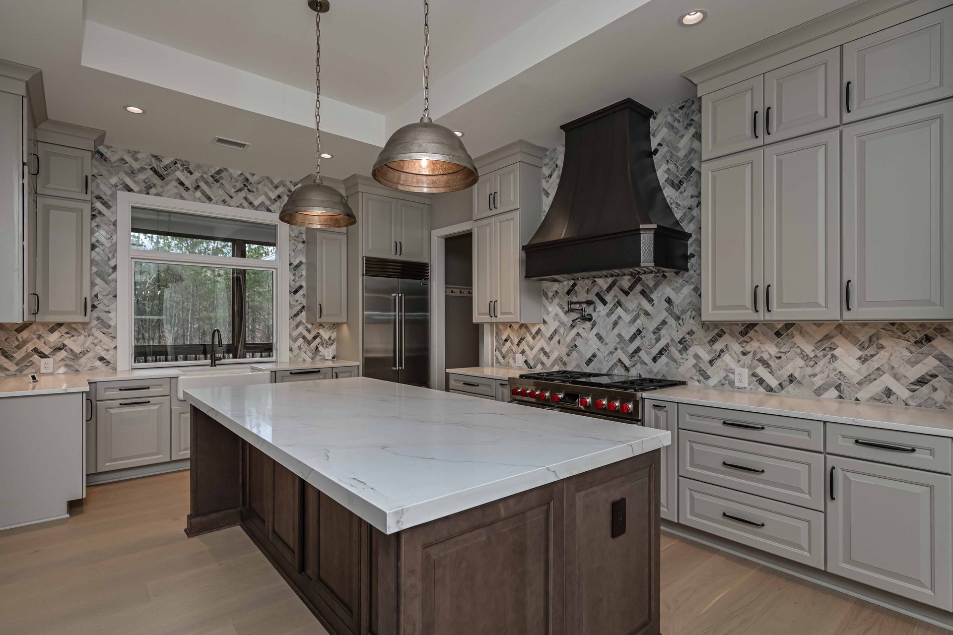 A kitchen with a large island in the middle of it.