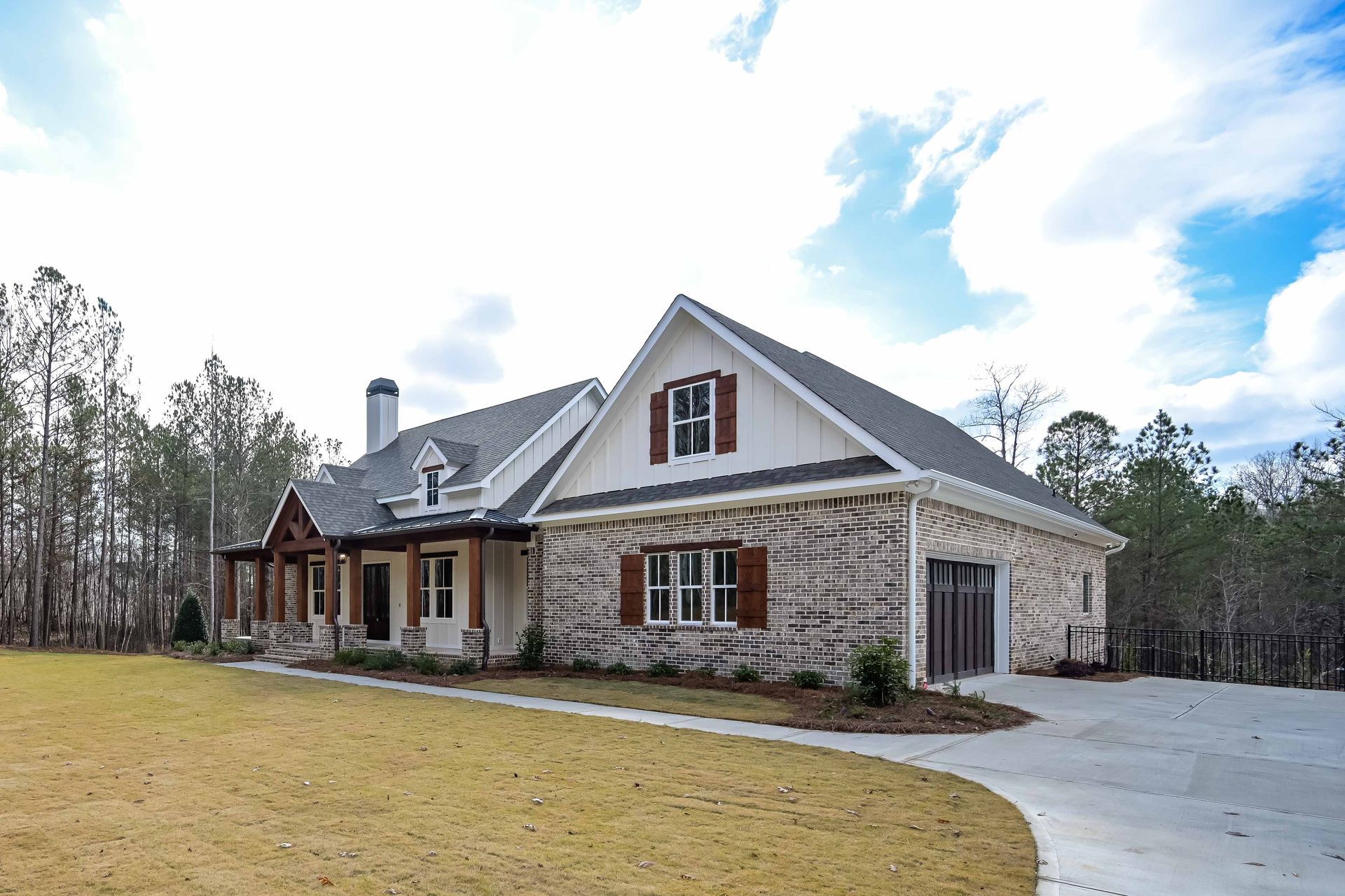 A large house with a lot of windows and a driveway