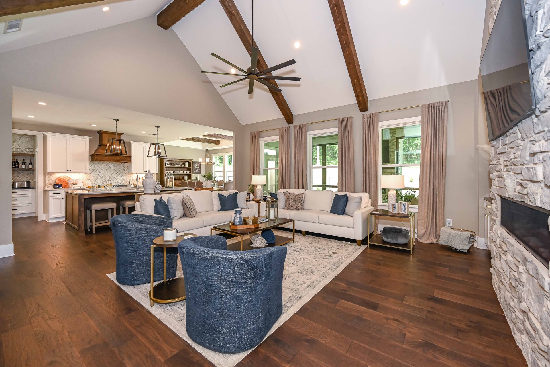 A living room filled with furniture and a ceiling fan.