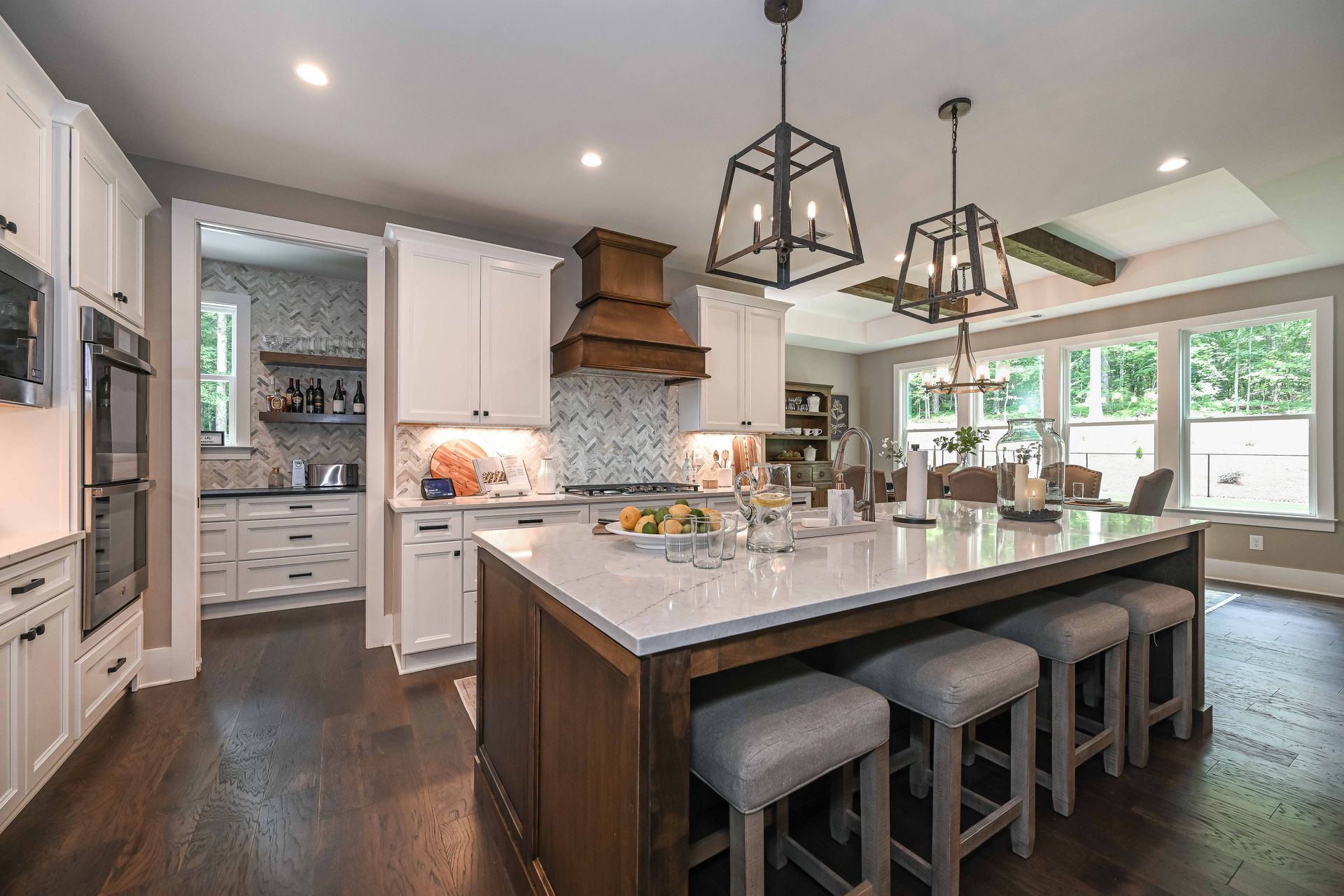 A large kitchen with a large island and stools.