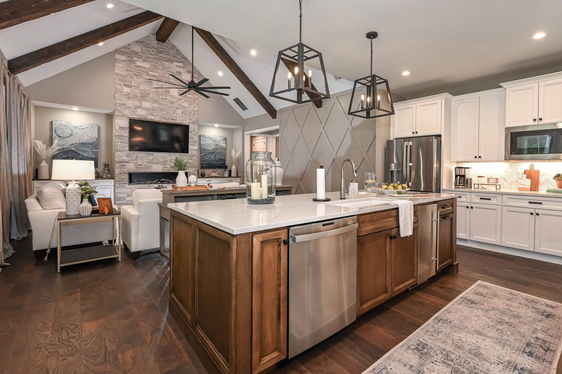 A kitchen with stainless steel appliances , wooden cabinets and a large island.