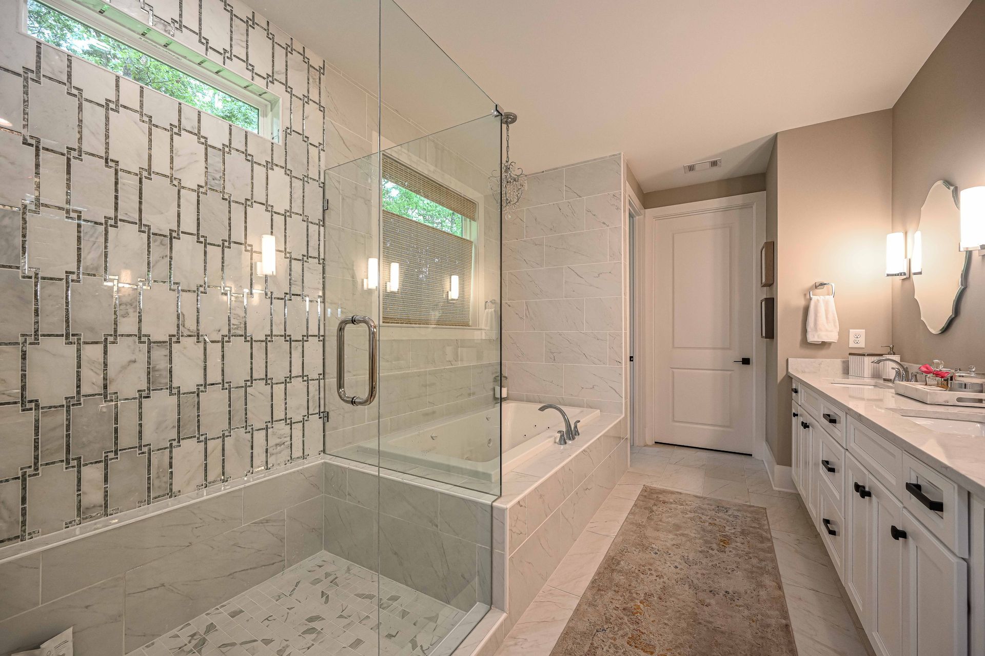 A bathroom with a walk in shower and a bathtub.