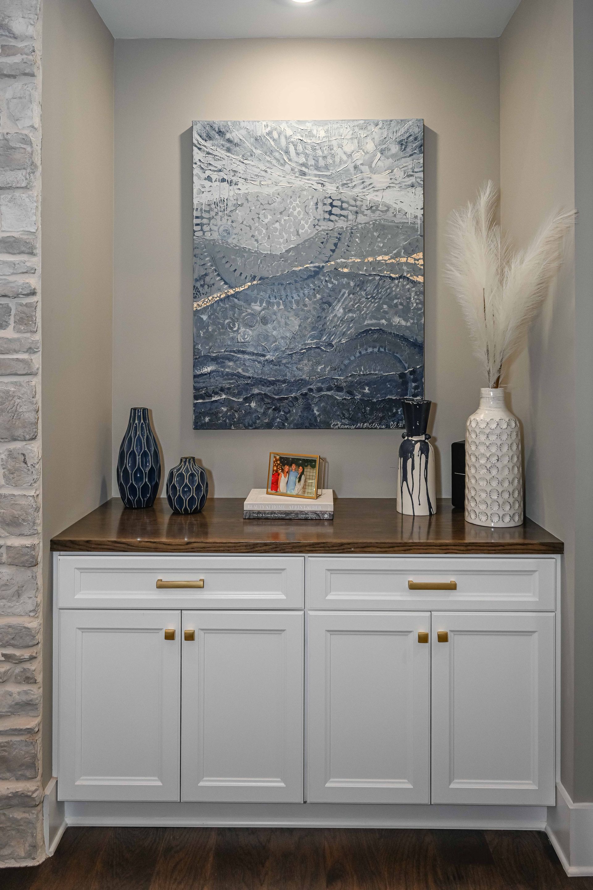 There is a painting on the wall above the cabinets.