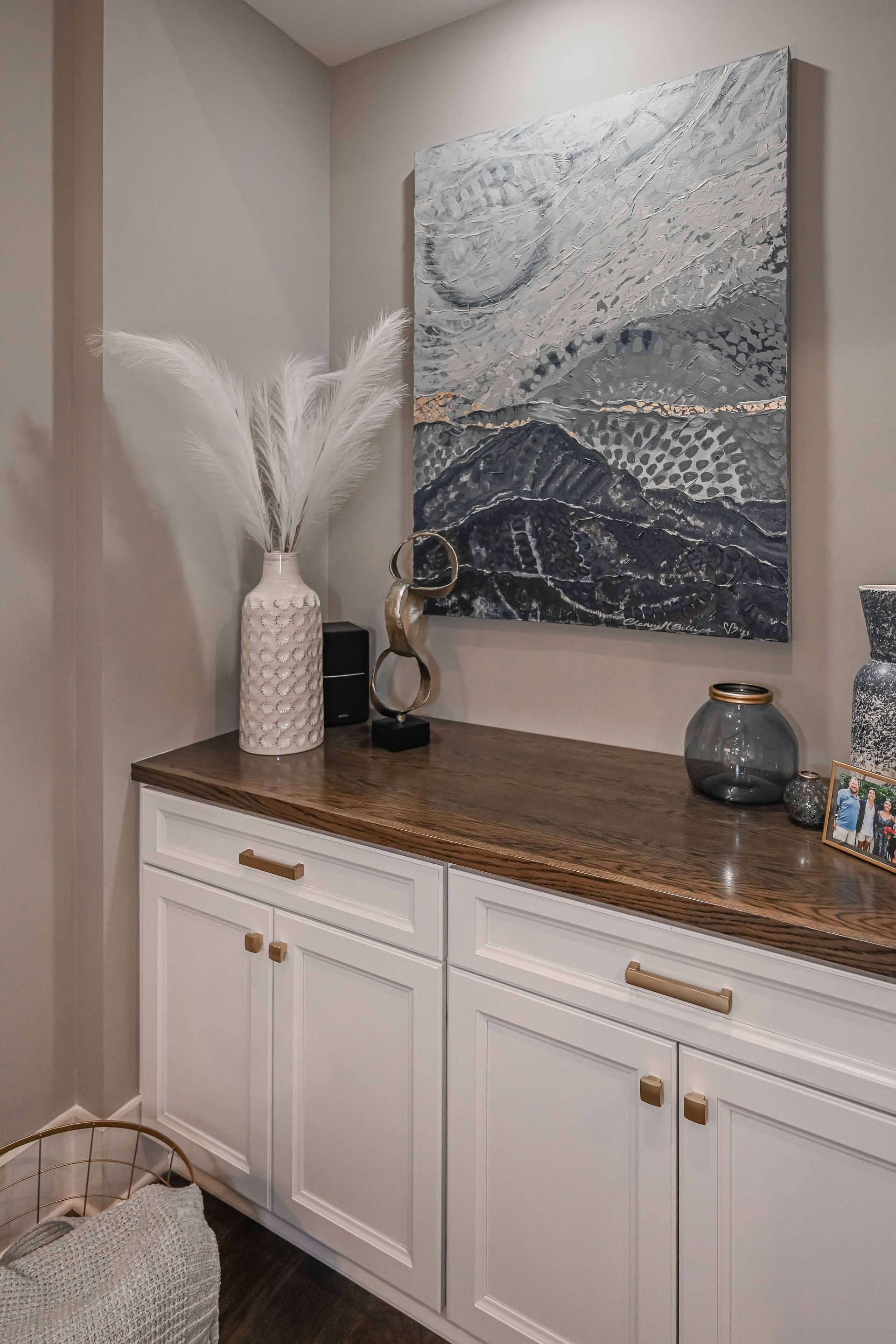 There is a painting on the wall above the cabinets.