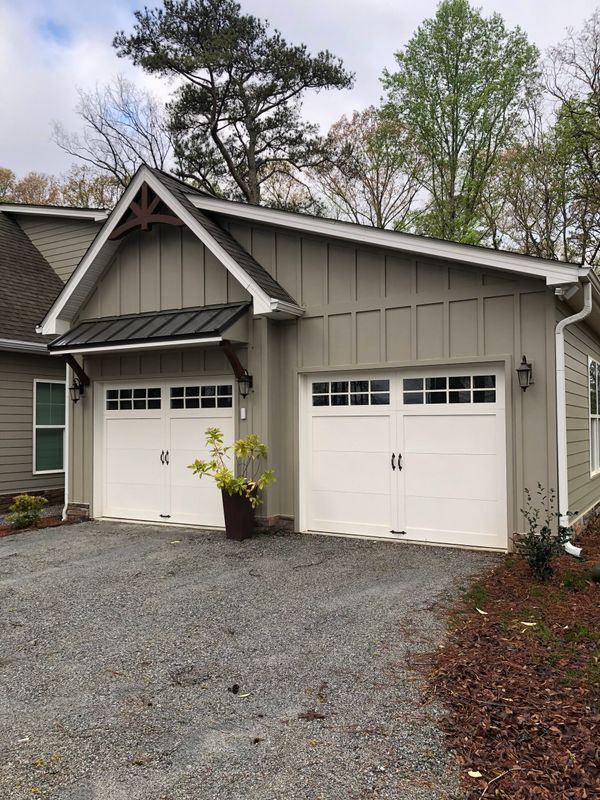 A house with two garage doors and a driveway