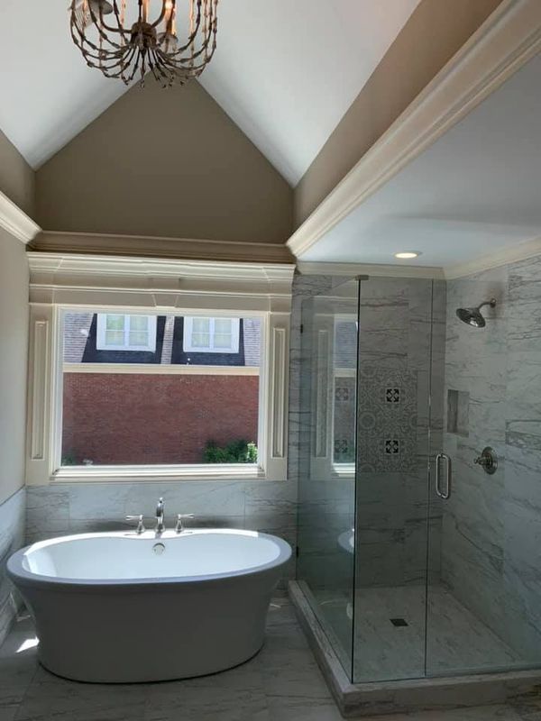 A bathroom with a bathtub and a walk in shower