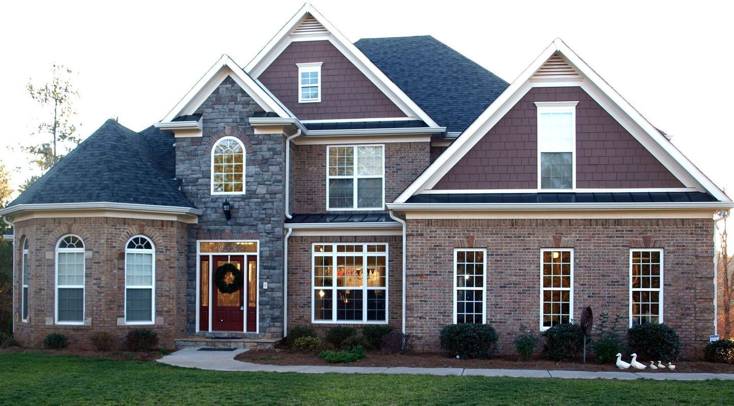 A large brick house with a wreath on the front door