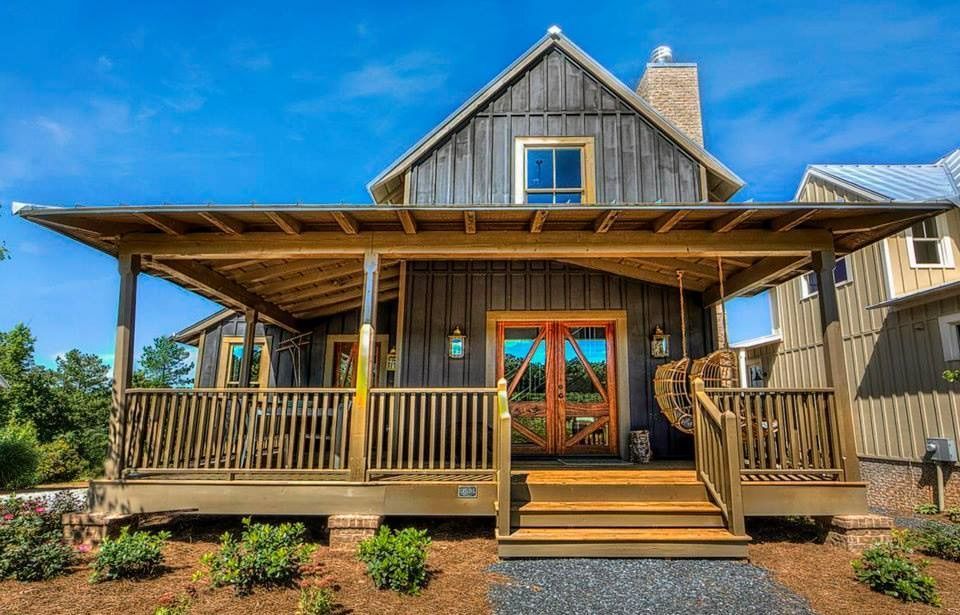 A house with a large porch and stairs leading up to it