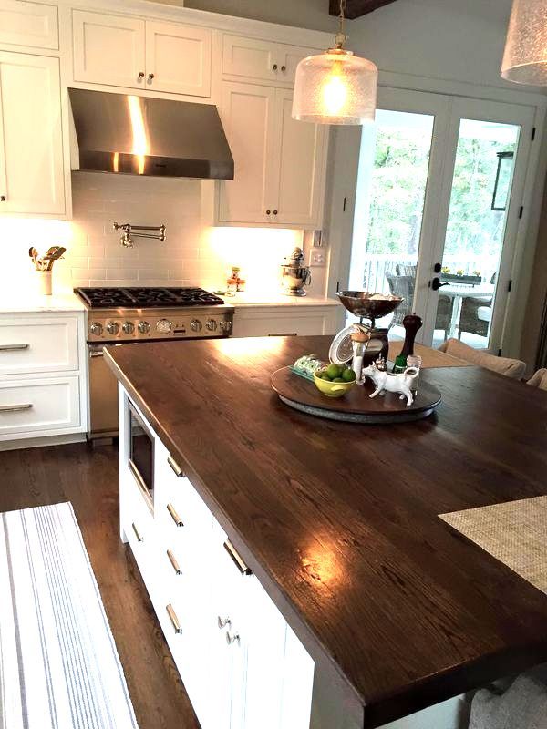 A kitchen with a large island and a stove top oven