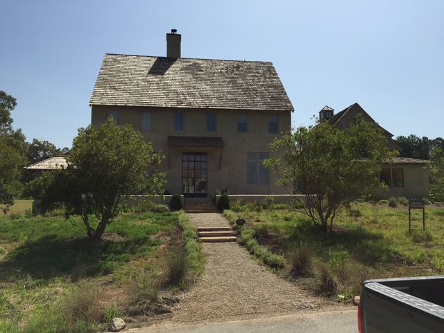 A truck is parked in front of a large house