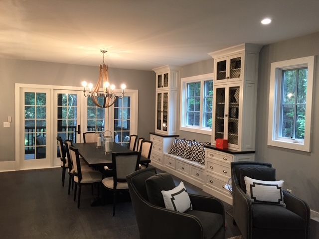 A dining room with a table and chairs and a chandelier