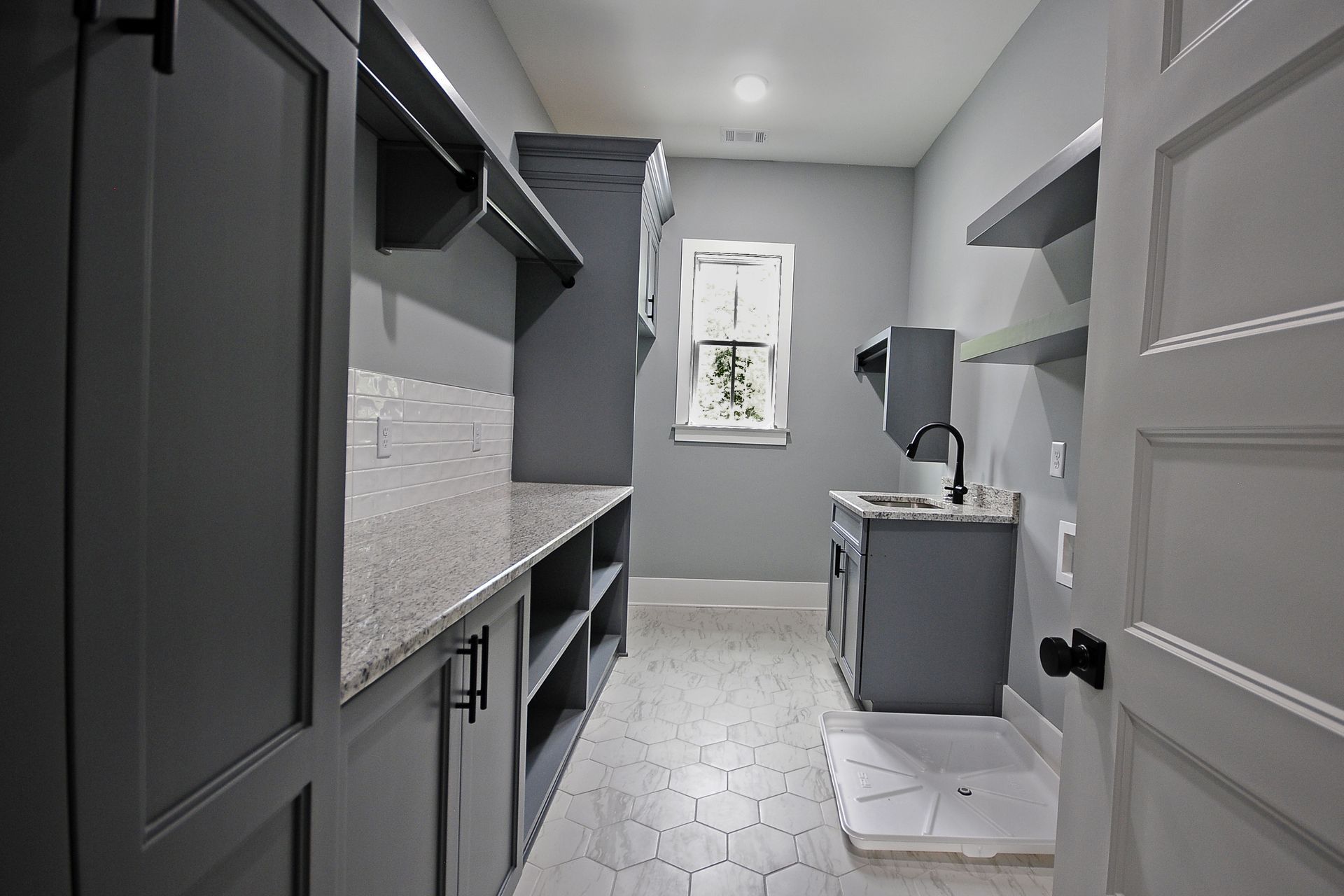 A laundry room with a washer and dryer and a window.