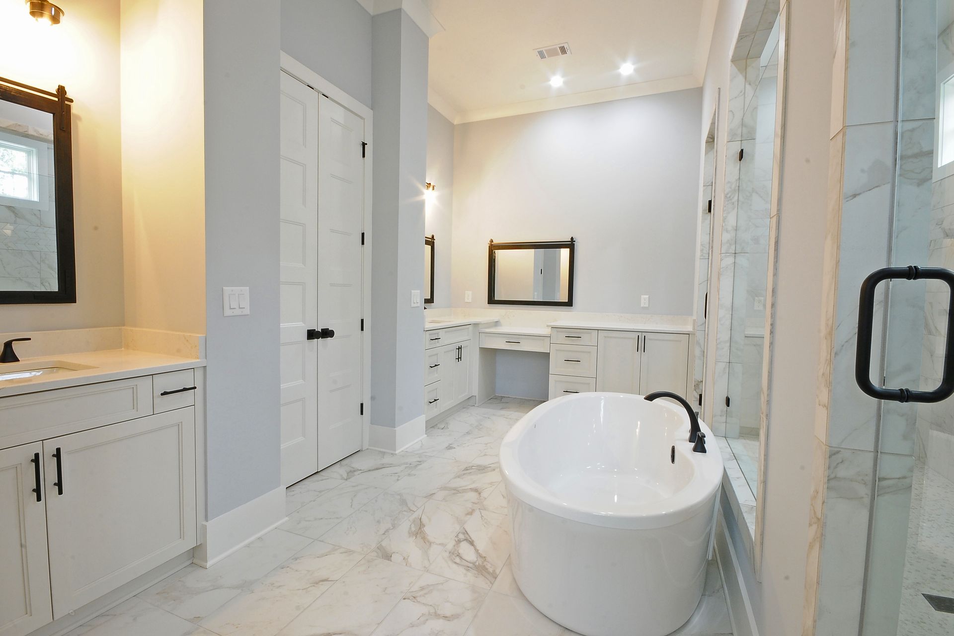 There is a large bathtub in the middle of the bathroom.